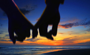 lover holding hand walking on the beach